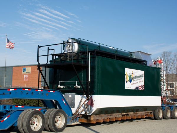 Trailer mounted boiler rental being delivered by truck