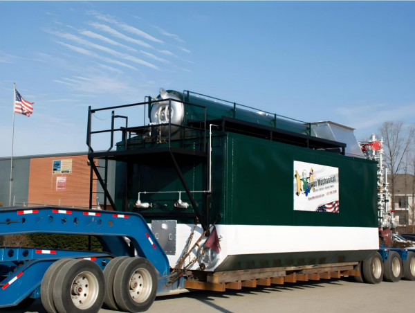 Trailer mounted boiler rental being delivered by truck